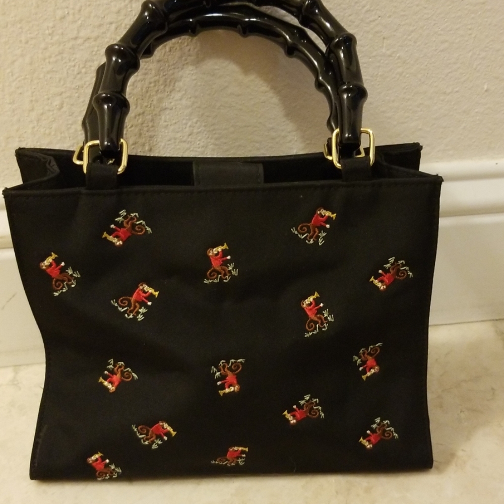 Prezzo bag with embroidered monkeys wooden handles